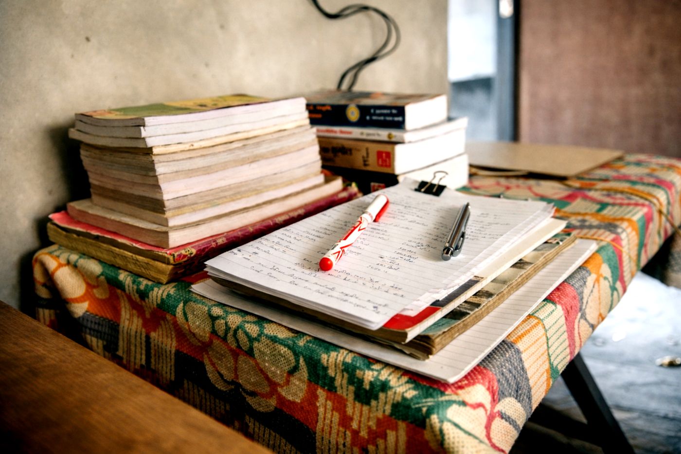 A study desk with notebooks and pens